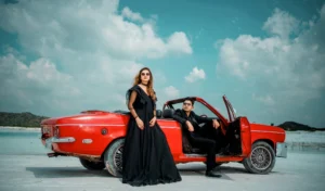 pre wedding photoshoot with red car and black outfit of couple